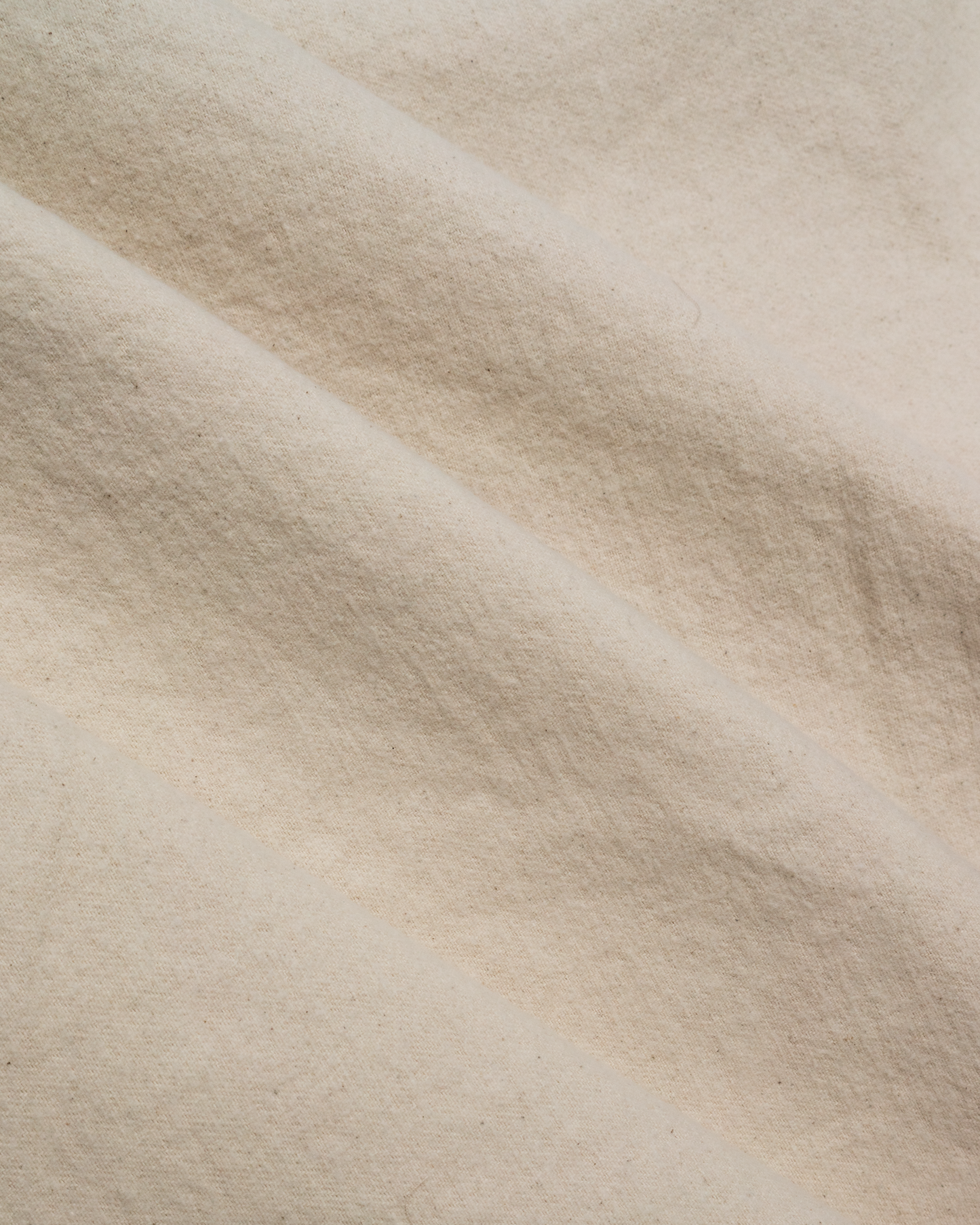 A close-up of draped fabric with a soft, textured surface