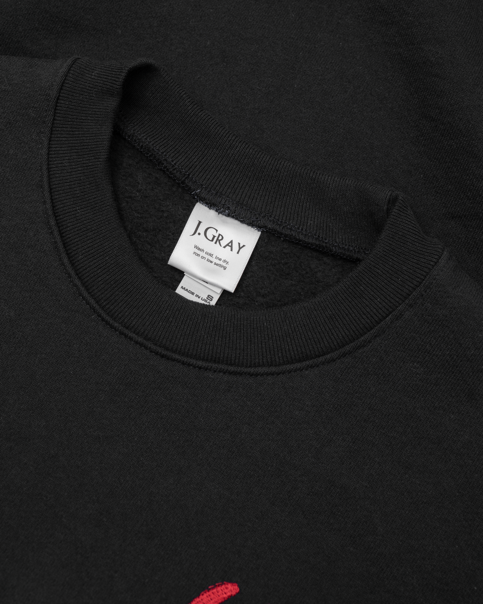 Dark navy blue sweater with red horseshoe and J. Gray brand tag