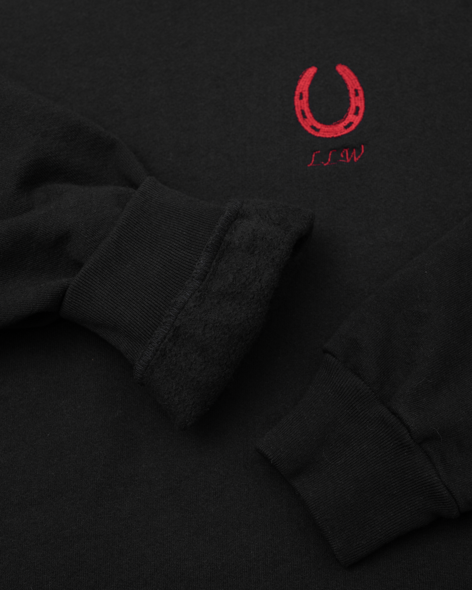 Dark navy blue sweater with red embroidered horseshoe