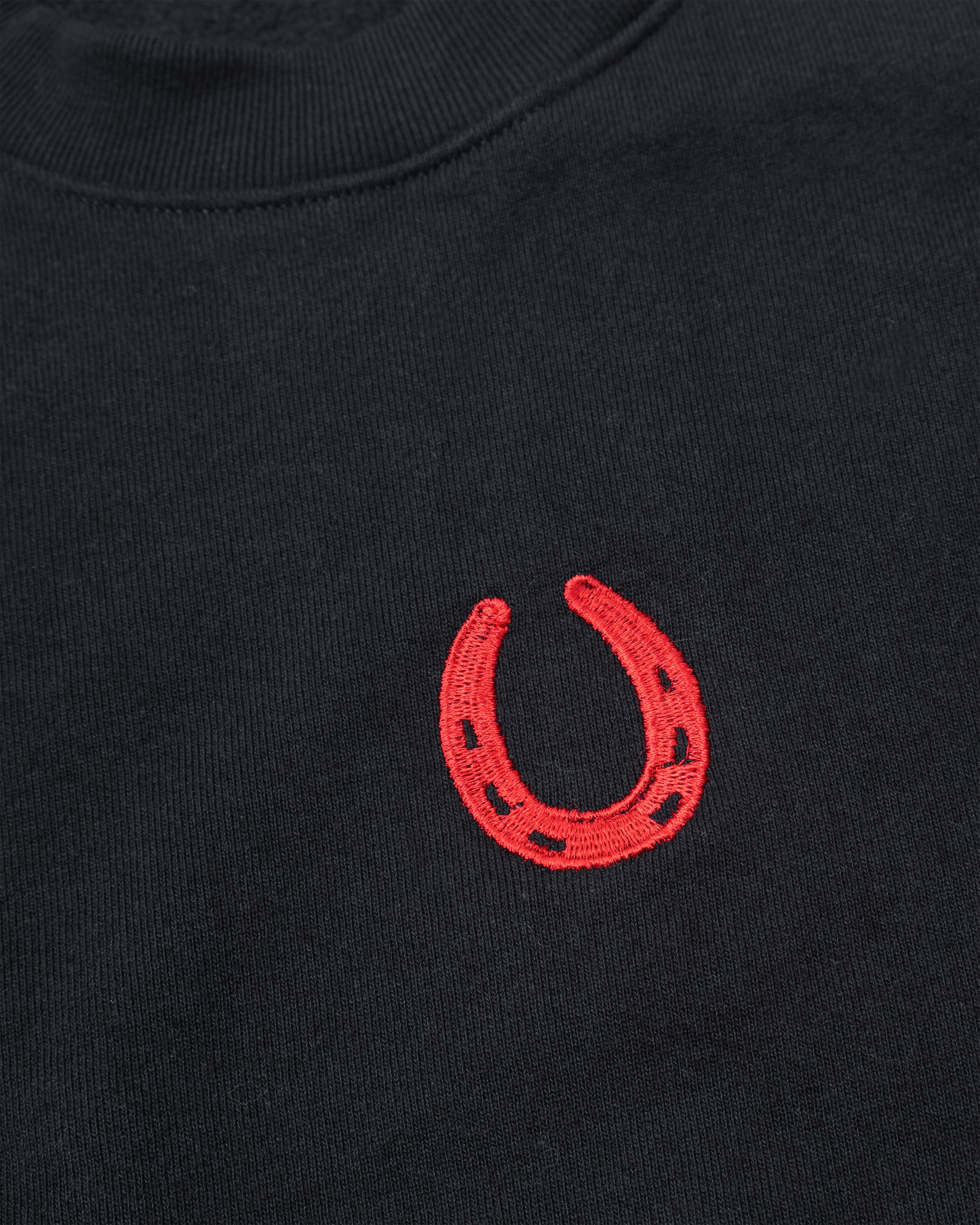 Dark navy blue sweater with red embroidered horseshoe